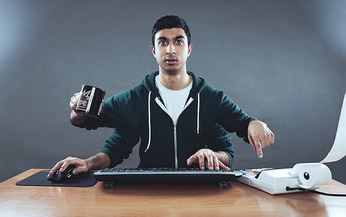 Man at desk multi-tasking